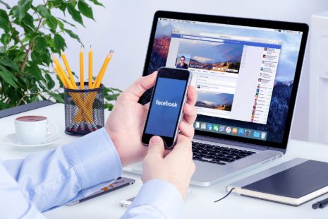 Smartphone and laptop displaying Facebook Ads, highlighting social media advertising.